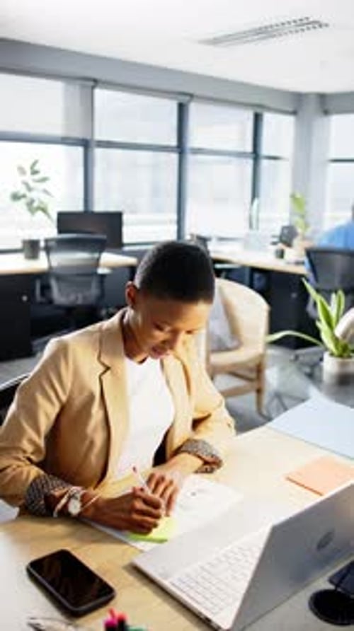 Vertical video of african american businesswoman working in office, slow motion, copy space