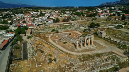 Ruins Of Temple Of Apollo At Delphi, Ancient Corinth In Greece. aerial orbiting shot