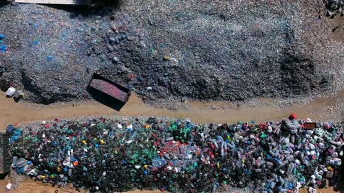 Plastic bottles and Trash Soda cans recycling piles in a local facility, Top down view