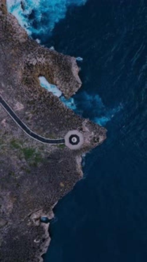 Drone Captures Curving Coastal Path Above Vibrant Turquoise Waters
