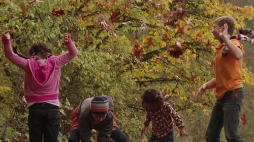 Kids Playing with Autumn Leaves