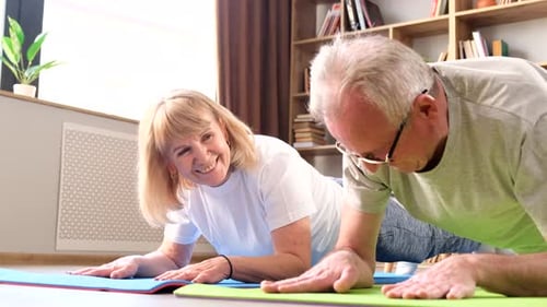 Senior Couple Planking on Exercise Mats at Home