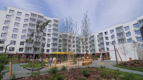 People with Children Spend Time on Playground in City