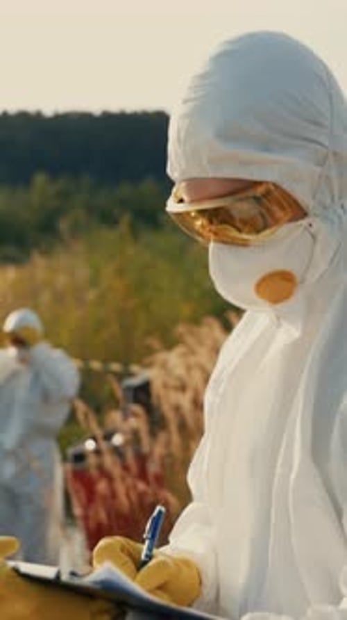 People in Hazmat Suits Taking Field Notes