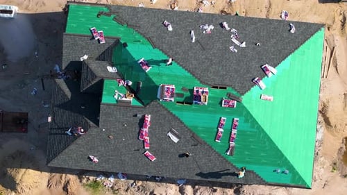 Roofing Crew Replacing Shingles on Residential House