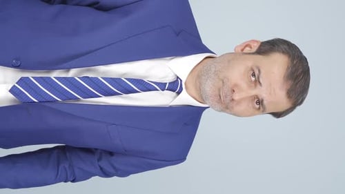 Man in Blue Suit Looking at Camera