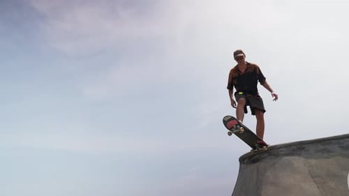 Wide Shot Pan Skateboarder Sliding Ramp in Skatepark at Day