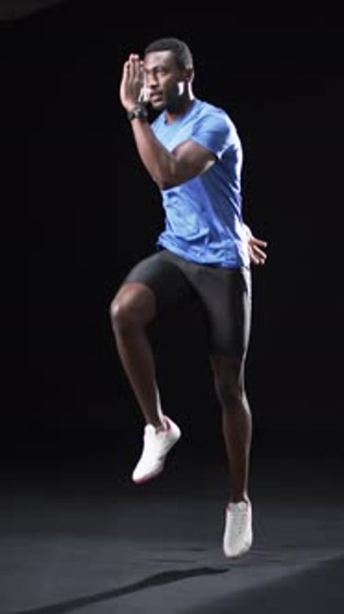 Athletic Man Doing High Knees in Studio
