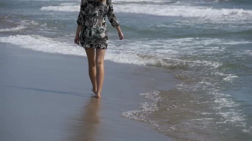 Girl in Bathing Suit Runs Along the Sea Shore at the Beach in Slow Motion