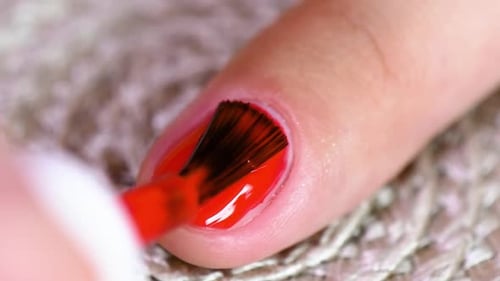 Applying Red Nail Polish Close Up