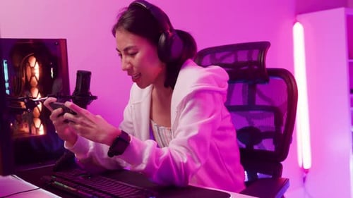 Enthusiastic Young Adult Gaming on Mobile Phone