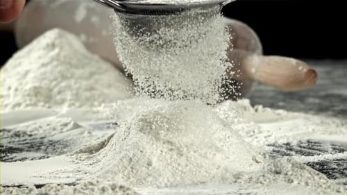 Sifting Flour Through Sieve for Baking Ingredients