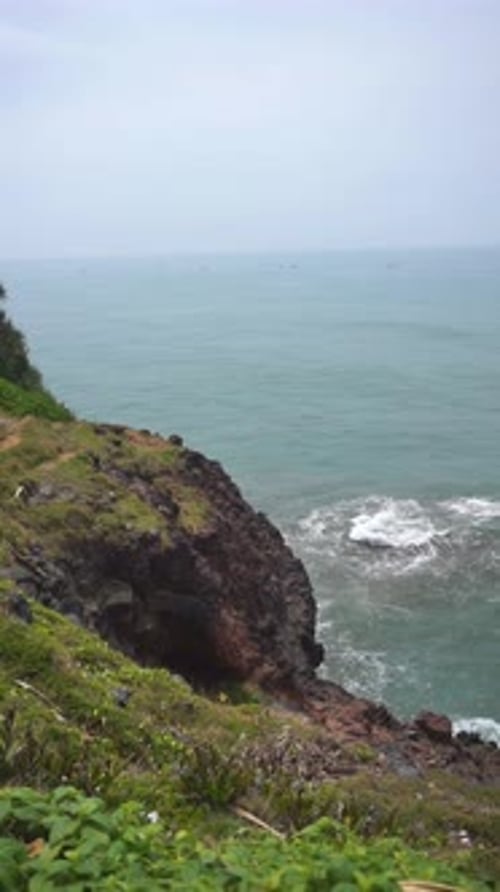 a wide expanse of sea, a coastline with blue sea water with big waves during the day