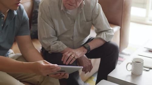Young Man Showing Tablet to Senior Man