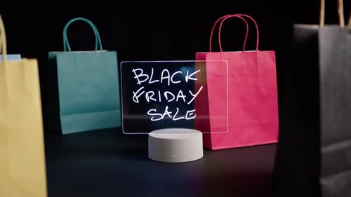 Colorful Shopping Bags Next to Lighted Sale Sign