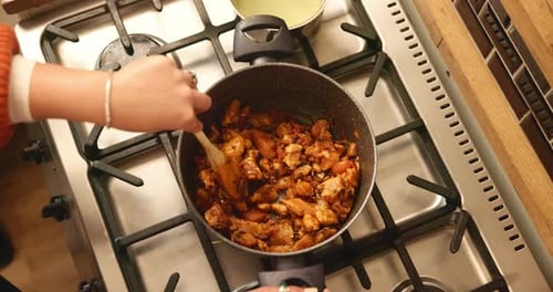 Pot, above and woman with food, hands and stir to mix ingredients, prepare lunch and recipe