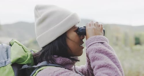 Young Woman Exploring Nature with Binoculars
