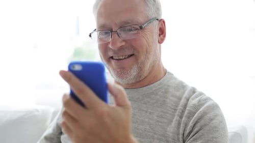 Senior Man Chatting Happily On Video Call