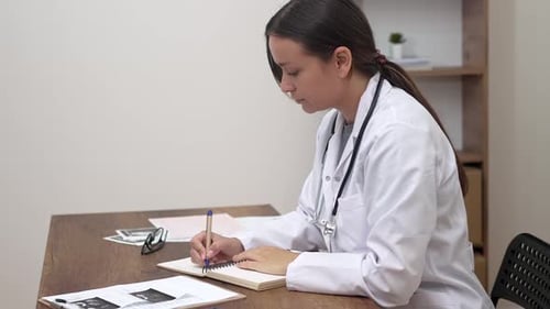 At Her Clinic Desk Doctor Examines Patient Test Data Concept of Modern Healthcare and Innovation