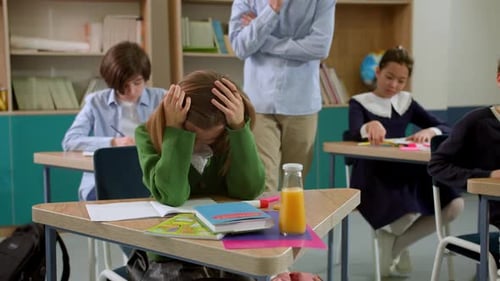 Elementary School Class Children Communicate with the Teacher Answering Question