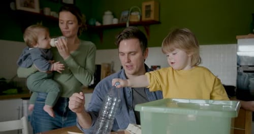 Family recycling at home with young children