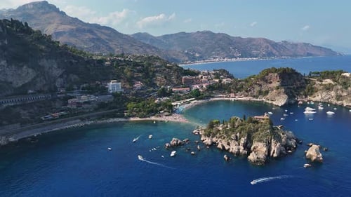 Beautiful aerial view of Isola Bella in Sicily surrounded by clear blue water and boats