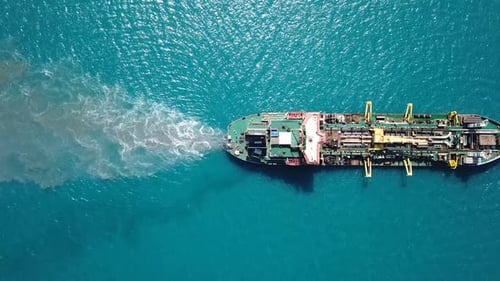 Trailing Suction Hopper-Dredger ship roaring across the sea