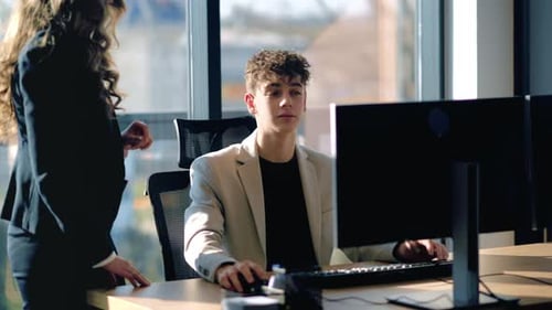 Young Adult Working in a Bright Corporate Office