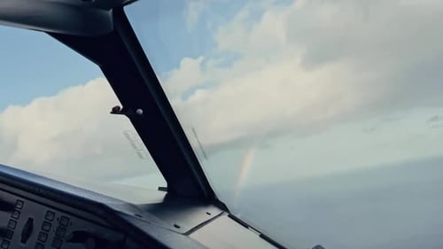 Rainbow seen from an aircraft cockpit turning in flight. Pilots view
