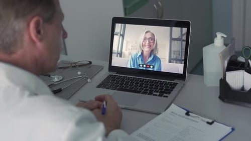 Older Male Doctor Consulting Senior Old Female Patient By Telemedicine Online Video Call. Physici...