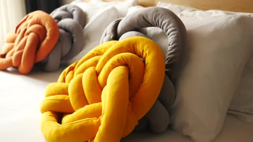 Stylish Knot Pillows on a Bed
