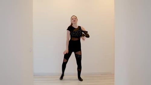 Young Woman Dances in Black Mesh Outfit