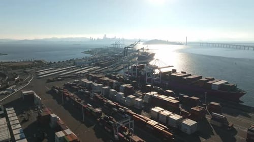 Logistics and Transportation of Container Cargo Ship with Working Crane Bridge in Shipyard