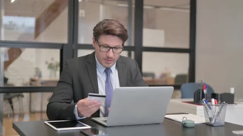 Man Online Shopping in Office with Credit Card
