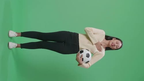 Full Body Of Asian Woman With A Ball Singing National Anthem While Cheering Soccer On Green Screen