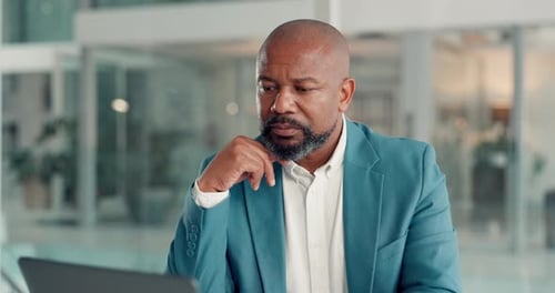 Business, man and thinking with laptop in office for financial report, revenue review or auditing