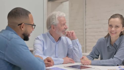 Close up of Old Businessman Talking During Meeting