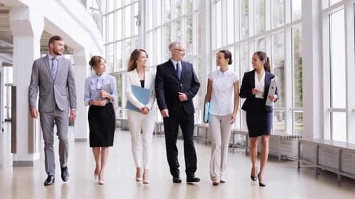 Diverse Business Team Walking in Modern Office Building