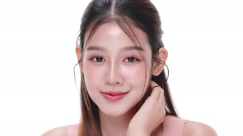 Close up portrait beautiful young Asian woman with healthy facial skin over white background.