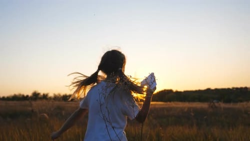 Follow to Happy Small Girl Running with a Paper Airplane Through Grass Field