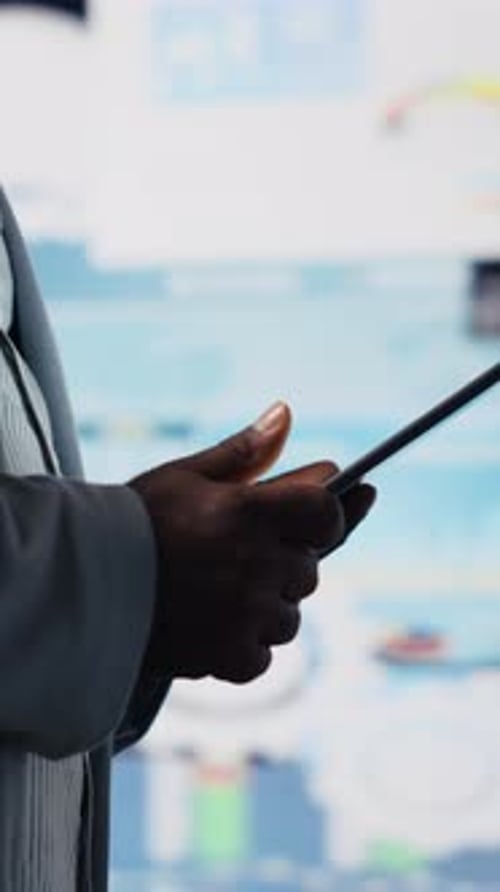 Vertical Video Black Male Entrepreneur Reviews Financial Graphs and KPI Models