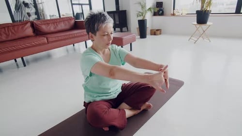 Woman Doing Hand Stretches on Yoga Mat