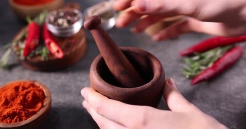 Spices being added to a mortar