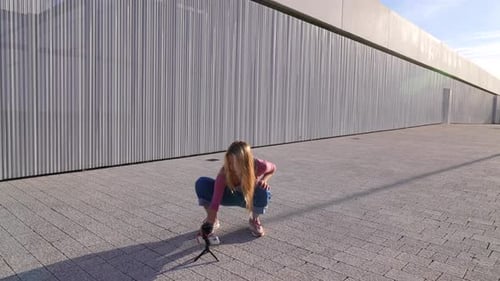 Young Woman Dances Outdoors, Filming Herself