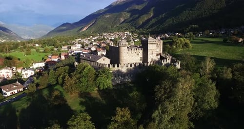 Aerial of Italian medieval castle on a scenic mountains valley panoramic view in 4k