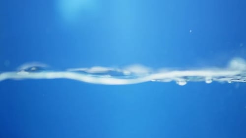 shot of water droplets creating intricate patterns, reflecting light for a shiny and creative look a