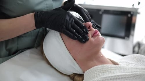 Pretty Girl Receiving Cosmetic Facial Care at a Spa Salon
