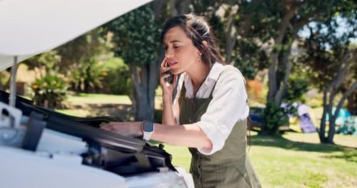 Woman Inspecting Car Engine Bay and Talking on Phone