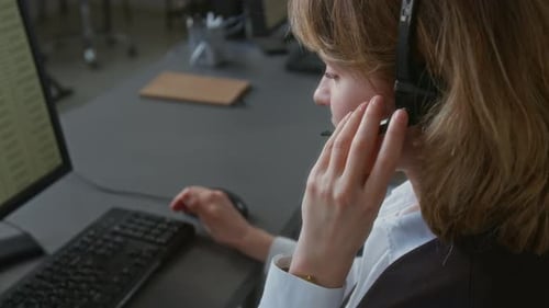 Girl Adjusting Microphone and Talking with Client Working in Call Center System