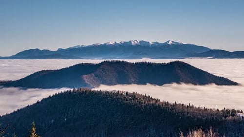 Winter Alps Mountains above Foggy Clouds in Cold Sunny Morning Landscape